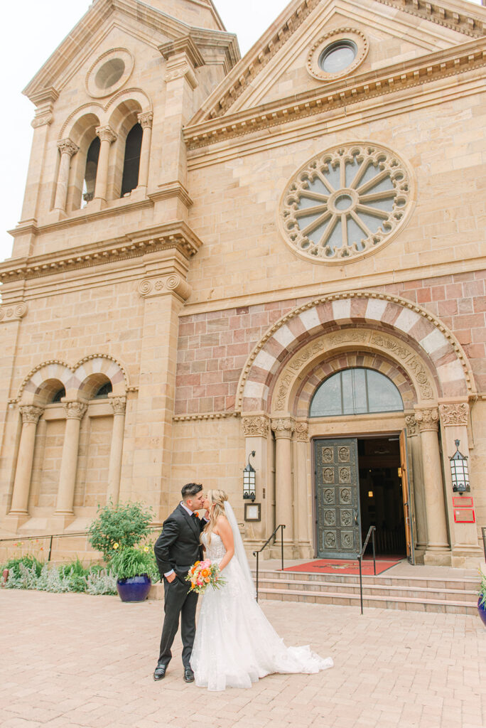 bride and groom in Santa Fe Plaza at the cathedral